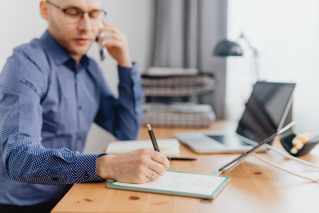 person%20talking%20on%20the%20phone%20and%20taking%20notes%20at%20their%20desk person%20talking%20on%20the%20phone%20and%20taking%20notes%20at%20their%20desk